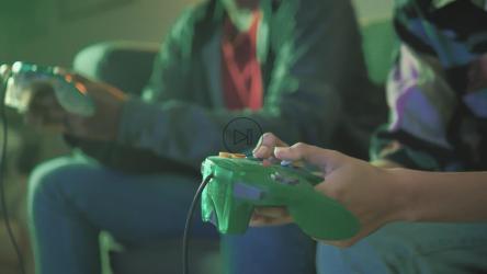 Two players pressing the buttons of a video game control[免费商用]