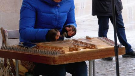 Playing a wooden xylophone on the street[]