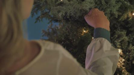 一个女孩触摸白雪皑皑的圣诞树的手[免费商用]