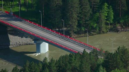 Cars crossing a bridge in the countryside[]