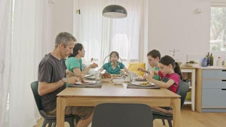 Family having pancakes for breakfast[]