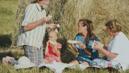 Family enjoying a picnic outdoors[]
