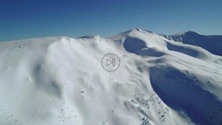 Air travel over a snow covered hill[4K]