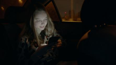 Girl on her cell phone in the backseat of a car[4K]