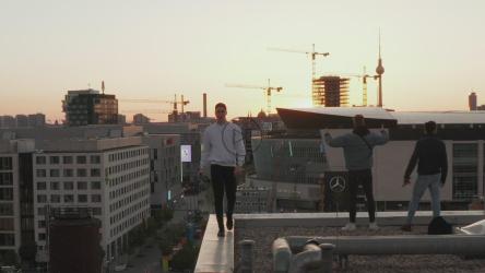 Boys enjoying the view of the city on the rooftop[]