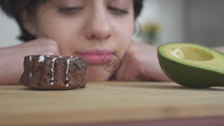 Girl making difficult choice between bad and good food[4K]