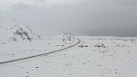 Road crossing a snowy landscape[4K]