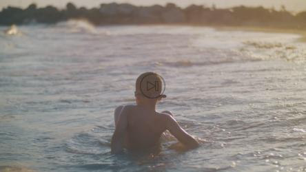 在海浪中玩耍的小男孩[]