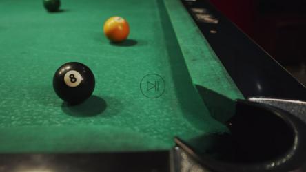 White billiard ball knocking number eight into corner pocket[]