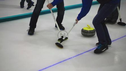 Curling stone players sweeping[]