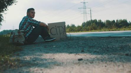 Hitchhiker with a cardboard sign[4K]