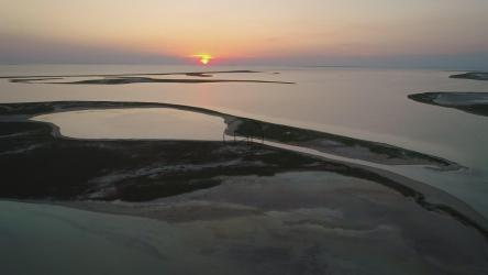 Abstract islands on a lake at sunset[4K]