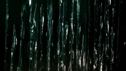 Running water falling against a dark screen[]