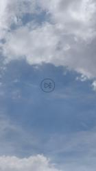 Two people shaking hands with the sky in the background[免费商用竖屏]