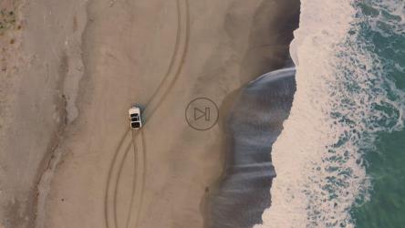 Car driving freely along the seashore at sunset[]