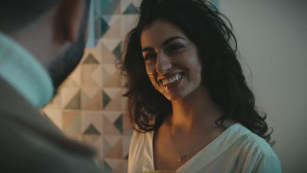 Girl dances and drinks coffee in the kitchen with her boyfriend[]