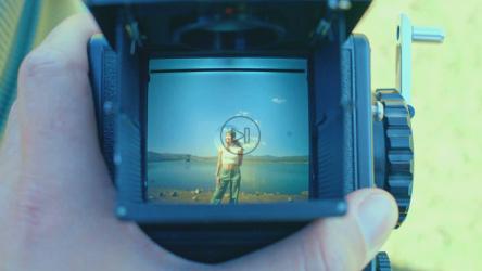 一位年轻女子在一台旧摄影相机的视口上[免费商用]