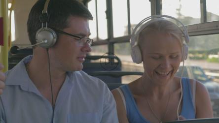 Couple listening to music on a bus[]