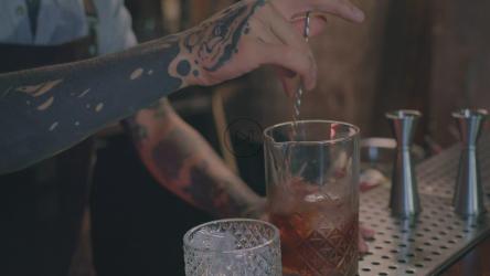 纹身的调酒师在酒吧里调酒[免费商用]