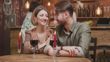 Couple on a date sharing wine[]