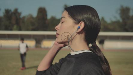 一名妇女在走路时摘下耳机[免费商用]