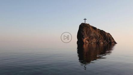 Crucifix on a cliff in the sea, landscape[]