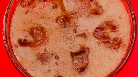 将可乐倒在加冰的玻璃杯上会产生苏打气泡和泡沫[免费商用]