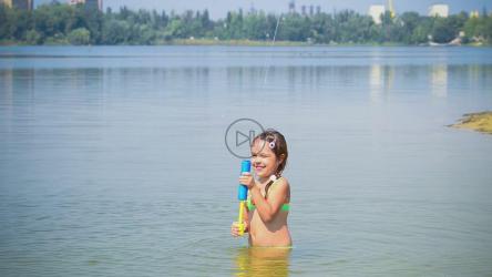 小女孩在湖中玩玩具[]