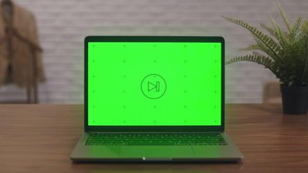 绿色屏幕桌子上的笔记本电脑[]