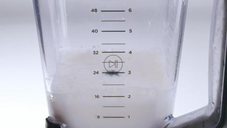 红色和黄色的新鲜水果落入装满牛奶的搅拌机中。[免费商用]