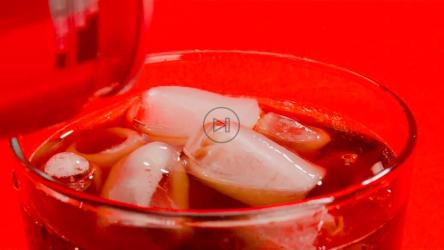 一个可乐汽水罐正在倒进一个装满冰块的杯子里[免费商用]